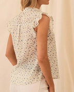 Blouse fleurie à volants et col montant